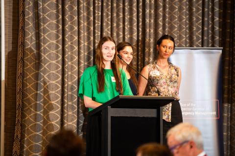 Natalie Oliver, Ali Gunn and Lillian Norris presenting at lecturn