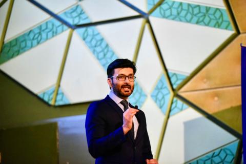 Adeel presenting on stage