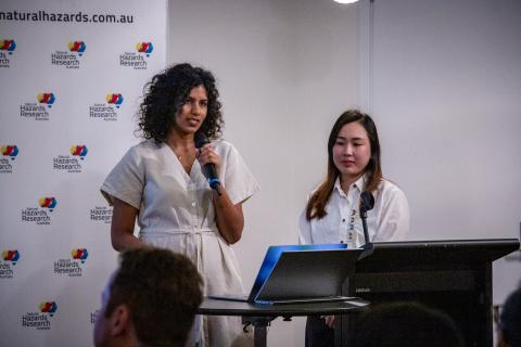 Two women speaking at lecturn